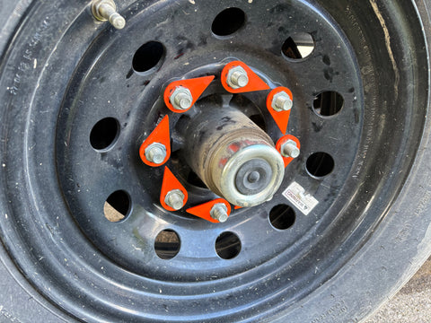 Torque-Tight 22mm orange lug nut indicator installed on dump trailer wheel