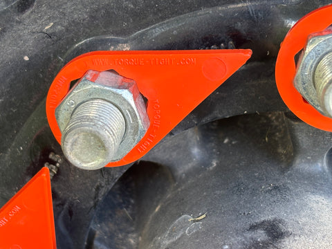 Torque-Tight 22mm orange lug nut indicator installed on dump trailer wheel