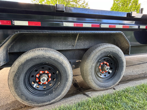 Torque-Tight 22mm orange lug nut indicator installed on dump trailer wheel