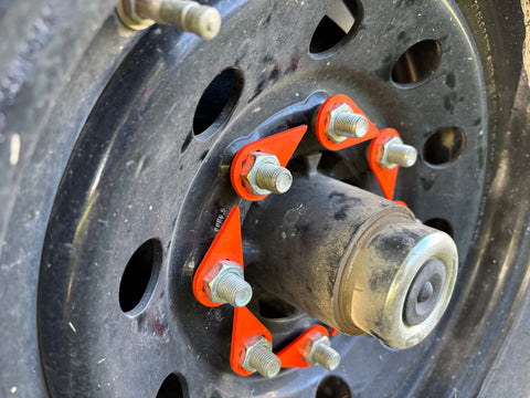 Torque-Tight 22mm orange lug nut indicators installed on dump trailer wheel